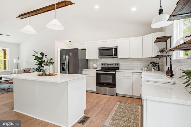 5903 Stubbs Bridge Rd, Mineral, VA 23117 - kitchen with appliances with stainless steel finishes, tasteful backsplash, white cabinetry, a sink, and high vaulted ceiling