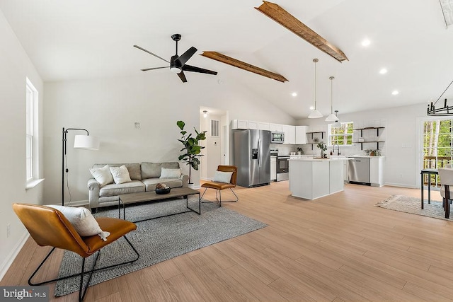 5903 Stubbs Bridge Rd, Mineral, VA 23117 - living room featuring a ceiling fan, light wood finished floors, high vaulted ceiling, baseboards, and beam ceiling