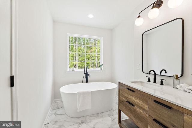 5903 Stubbs Bridge Rd, Mineral, VA 23117 - bathroom featuring a freestanding bath, marble finish floors, vanity, baseboards, and recessed lighting