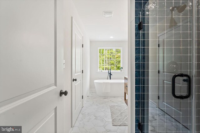 5903 Stubbs Bridge Rd, Mineral, VA 23117 - full bathroom with marble finish floors, a stall shower, a freestanding tub, and recessed lighting