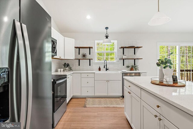5903 Stubbs Bridge Rd, Mineral, VA 23117 - kitchen featuring appliances with stainless steel finishes, open shelves, backsplash, pendant lighting, and white cabinets