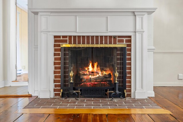 887 Natural Chimneys Rd, Mount Solon, VA 22843 - detailed view of a brick fireplace, wood finished floors, and baseboards