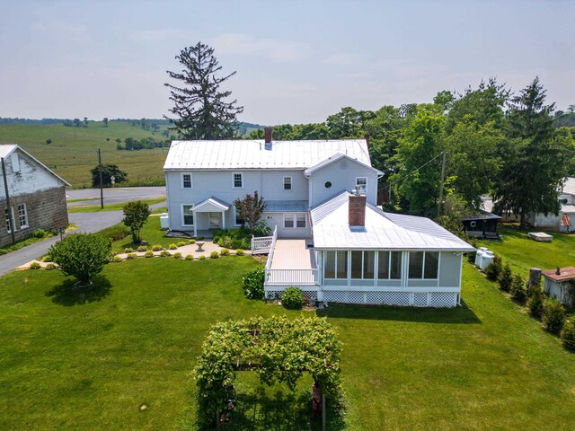 887 Natural Chimneys Rd, Mount Solon, VA 22843 - rear view of property featuring a chimney, metal roof, a yard, and a sunroom