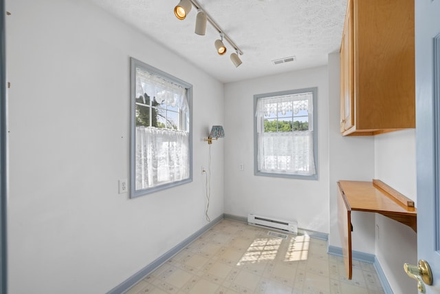 887 Natural Chimneys Rd, Mount Solon, VA 22843 - doorway featuring baseboard heating, light floors, rail lighting, a textured ceiling, and baseboards