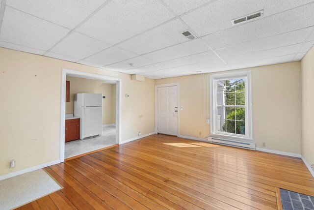 887 Natural Chimneys Rd, Mount Solon, VA 22843 - spare room with light wood-type flooring, baseboards, a drop ceiling, and a baseboard radiator