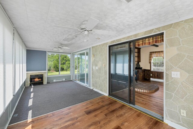 887 Natural Chimneys Rd, Mount Solon, VA 22843 - unfurnished sunroom featuring a fireplace, ceiling fan, and a baseboard heating unit