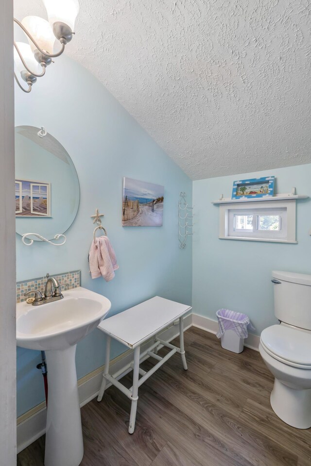 887 Natural Chimneys Rd, Mount Solon, VA 22843 - half bathroom with a textured ceiling, lofted ceiling, toilet, wood finished floors, and baseboards