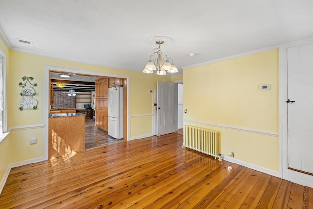 887 Natural Chimneys Rd, Mount Solon, VA 22843 - unfurnished dining area with radiator, baseboards, wood-type flooring, a chandelier, and ornamental molding