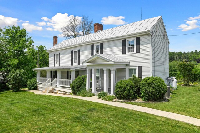 887 Natural Chimneys Rd, Mount Solon, VA 22843 - view of front of home with a chimney, covered porch, a front lawn, and a standing seam roof