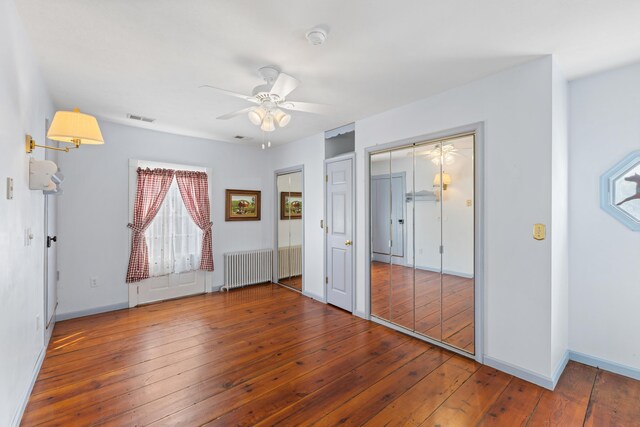 887 Natural Chimneys Rd, Mount Solon, VA 22843 - unfurnished bedroom with radiator heating unit, hardwood / wood-style flooring, baseboards, and a ceiling fan