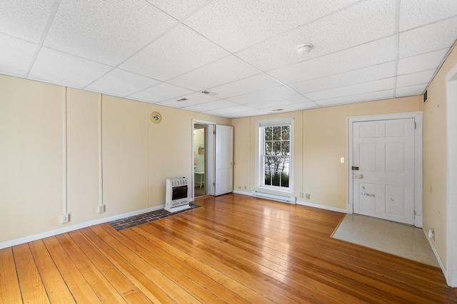 887 Natural Chimneys Rd, Mount Solon, VA 22843 - unfurnished living room featuring a drop ceiling, heating unit, light wood-type flooring, and baseboards
