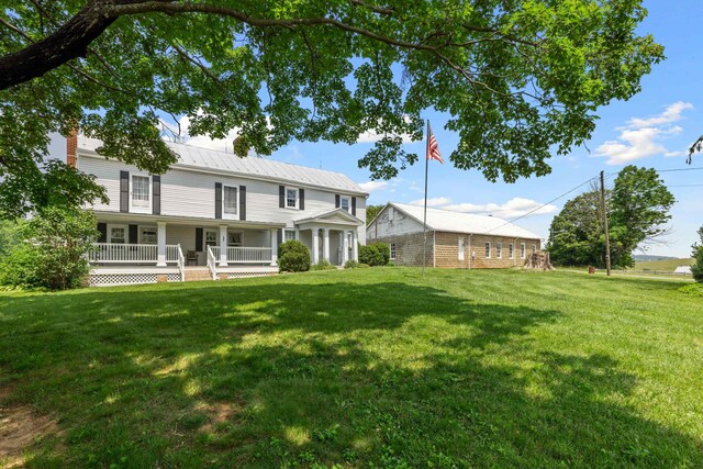 887 Natural Chimneys Rd, Mount Solon, VA 22843 - view of front of house featuring a chimney, a front yard, a porch, and metal roof