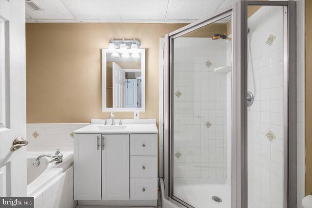  - bathroom featuring a stall shower, vanity, and a garden tub