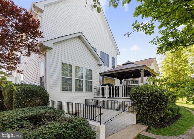  - view of front of property with a gazebo and a wooden deck