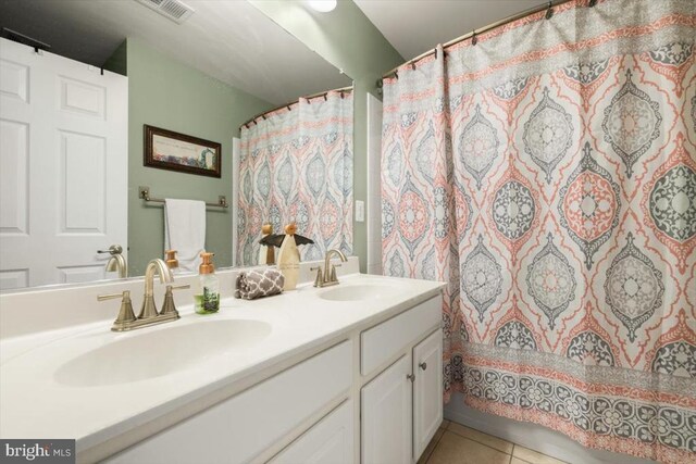  - bathroom with double vanity, tile patterned floors, and a shower with curtain