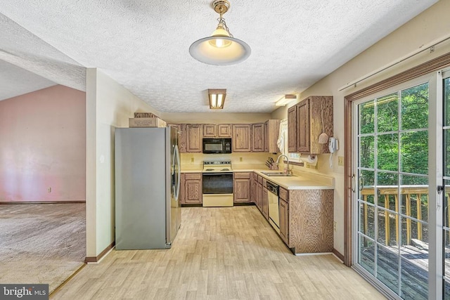 3716 Martin Kings Rd, Charlottesville, VA 22902 - kitchen featuring white appliances, light wood finished floors, light countertops, a textured ceiling, and brown cabinets