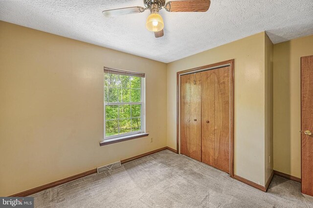3716 Martin Kings Rd, Charlottesville, VA 22902 - unfurnished bedroom with carpet flooring, a closet, a textured ceiling, and ceiling fan