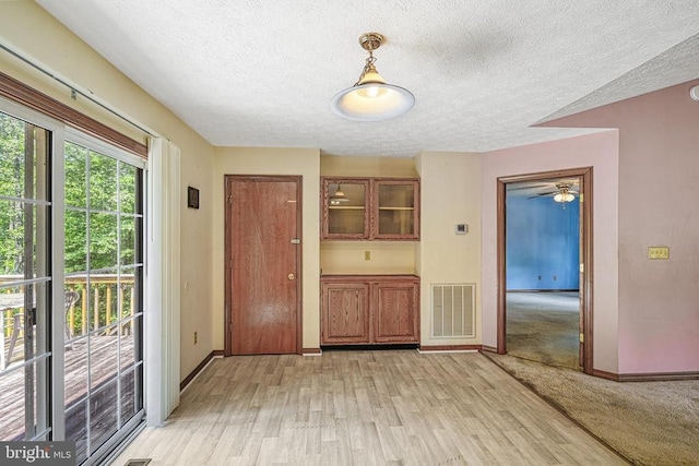 3716 Martin Kings Rd, Charlottesville, VA 22902 - unfurnished dining area featuring light wood-style flooring, a textured ceiling, and ceiling fan