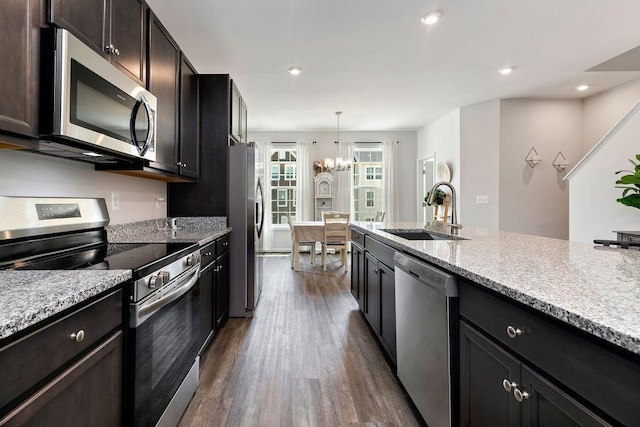 301 Willowshire Ct, Waynesboro, VA 22980 - kitchen with appliances with stainless steel finishes, dark wood finished floors, a chandelier, light stone counters, and recessed lighting