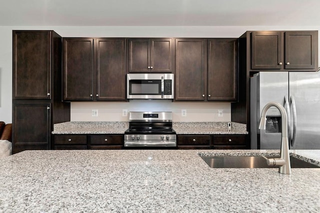 301 Willowshire Ct, Waynesboro, VA 22980 - kitchen with stainless steel appliances, dark brown cabinets, and light stone countertops