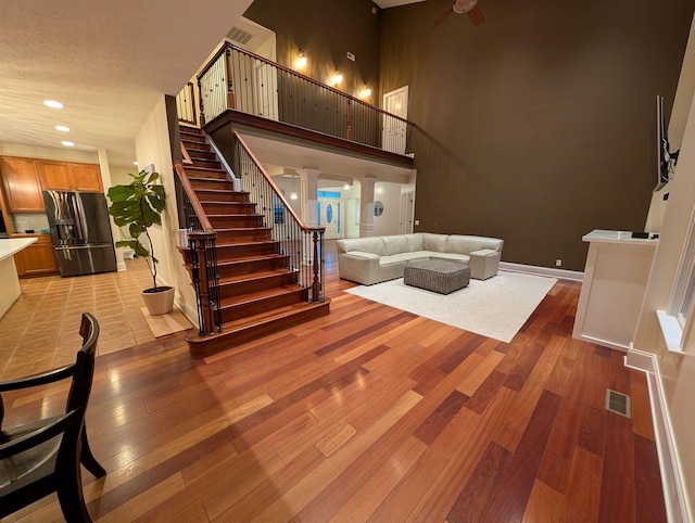 109 Leavel Ct, Bridgewater, VA 22812 - living area with light wood-style floors, stairs, ceiling fan, recessed lighting, and a high ceiling