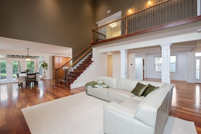 109 Leavel Ct, Bridgewater, VA 22812 - living room with a towering ceiling, decorative columns, wood finished floors, stairs, and plenty of natural light