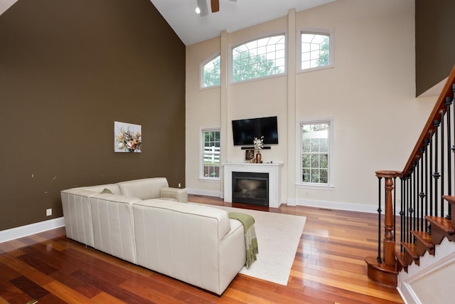 109 Leavel Ct, Bridgewater, VA 22812 - living area with high vaulted ceiling, wood finished floors, stairway, and healthy amount of natural light