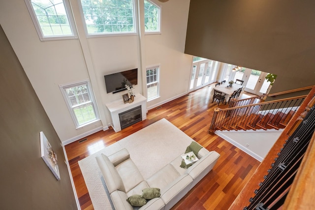 109 Leavel Ct, Bridgewater, VA 22812 - living area with a high ceiling, wood finished floors, baseboards, a glass covered fireplace, and french doors