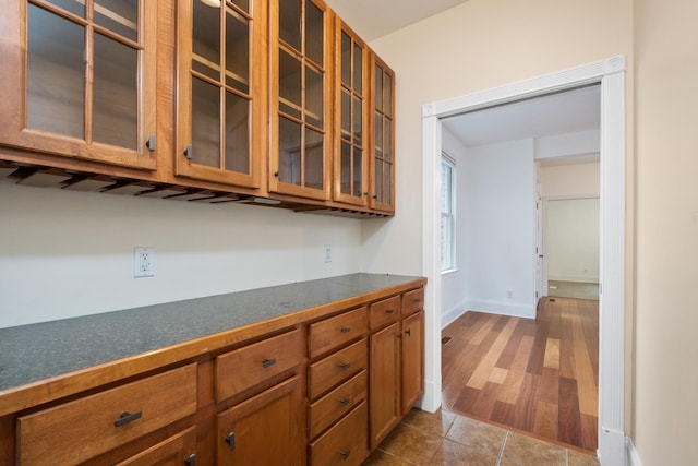 109 Leavel Ct, Bridgewater, VA 22812 - kitchen featuring brown cabinets, dark countertops, glass insert cabinets, and dark wood-style flooring