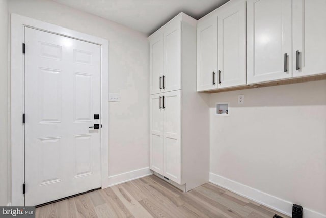 7143 Kirtley Trl, Culpeper, VA 22701 - laundry area with light wood-type flooring, baseboards, washer hookup, and cabinet space
