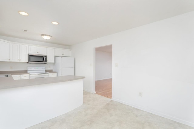 kitchen featuring white appliances and white cabinets