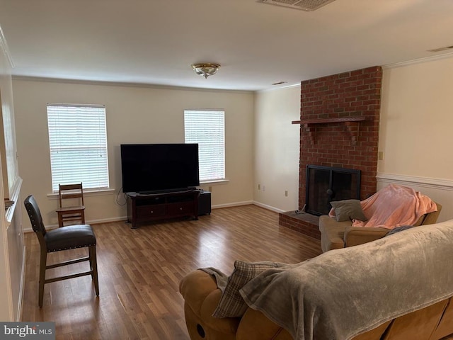 319 Fox Hunters Ln, Madison, VA 22727 - living area featuring crown molding, wood finished floors, plenty of natural light, a brick fireplace, and baseboards