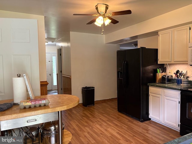 319 Fox Hunters Ln, Madison, VA 22727 - kitchen with black appliances, a ceiling fan, backsplash, light wood finished floors, and dark countertops