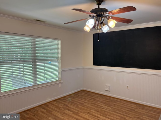 319 Fox Hunters Ln, Madison, VA 22727 - spare room featuring wood finished floors, a ceiling fan, crown molding, baseboards, and a wainscoted wall
