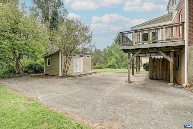 807 Hillcrest Rd, Charlottesville, VA 22903 - view of patio / terrace with a wooden deck, an outbuilding, asphalt driveway, and a carport