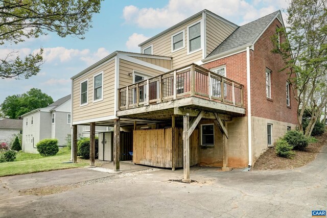 807 Hillcrest Rd, Charlottesville, VA 22903 - rear view of house with brick siding, driveway, a wooden deck, and a carport