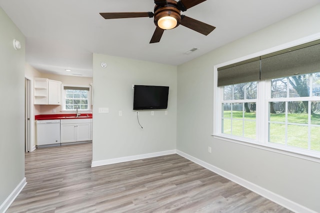 1204 Westmoreland Dr, Staunton, VA 24401 - unfurnished living room with baseboards, light wood-style flooring, ceiling fan, and a sink
