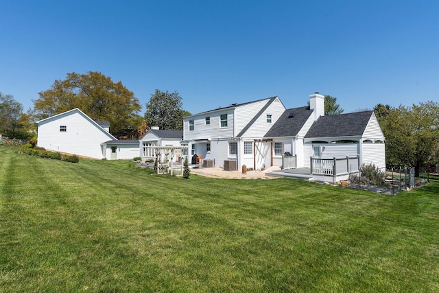 1204 Westmoreland Dr, Staunton, VA 24401 - back of house with a yard, a chimney, a wooden deck, and cooling unit