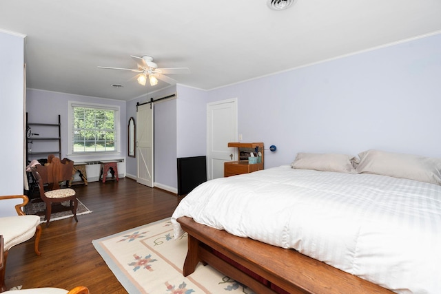 1204 Westmoreland Dr, Staunton, VA 24401 - bedroom with a barn door, dark wood-style flooring, ceiling fan, baseboards, and crown molding