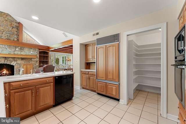 8300 Falcon Glen Rd, Warrenton, VA 20186 - kitchen with lofted ceiling, black appliances, visible vents, light countertops, and light tile patterned floors