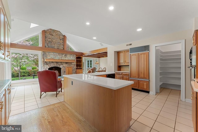 8300 Falcon Glen Rd, Warrenton, VA 20186 - kitchen featuring paneled built in refrigerator, visible vents, a fireplace, a wealth of natural light, and light countertops