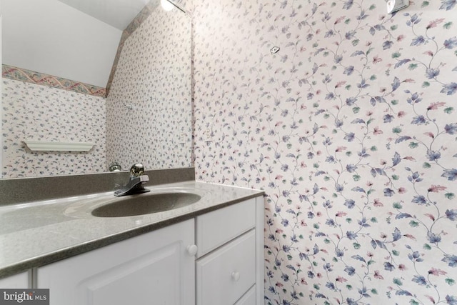 8300 Falcon Glen Rd, Warrenton, VA 20186 - bathroom featuring vanity, wallpapered walls, and vaulted ceiling