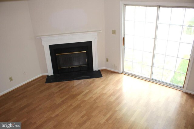 5151 Dominion Dr, Fredericksburg, VA 22407 - details featuring baseboards, a fireplace with flush hearth, and wood finished floors