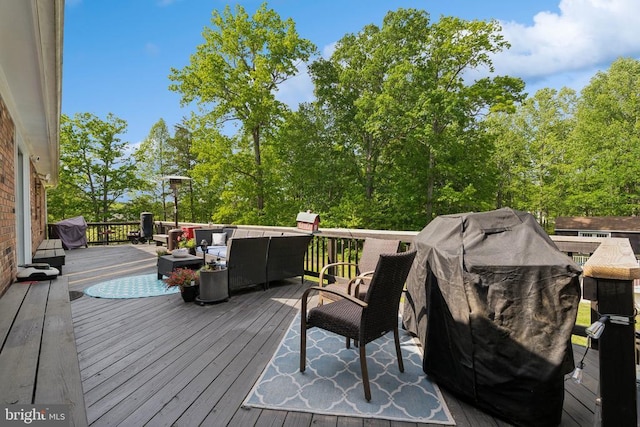  - wooden deck with an outdoor hangout area and a grill