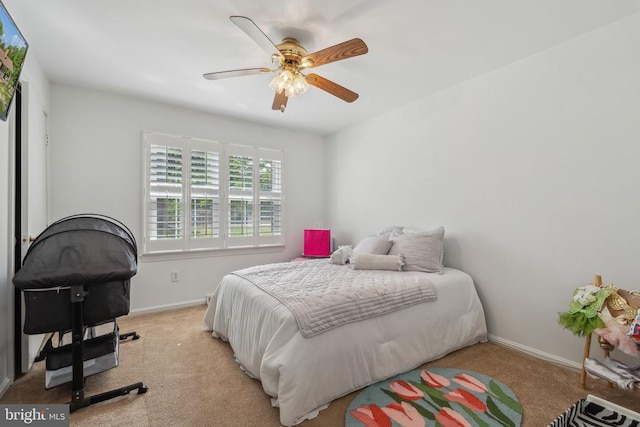  - bedroom featuring light carpet and ceiling fan