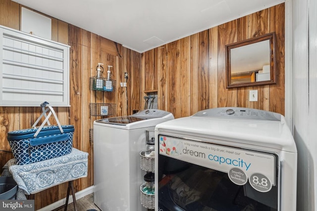  - laundry room featuring washer and clothes dryer and wooden walls