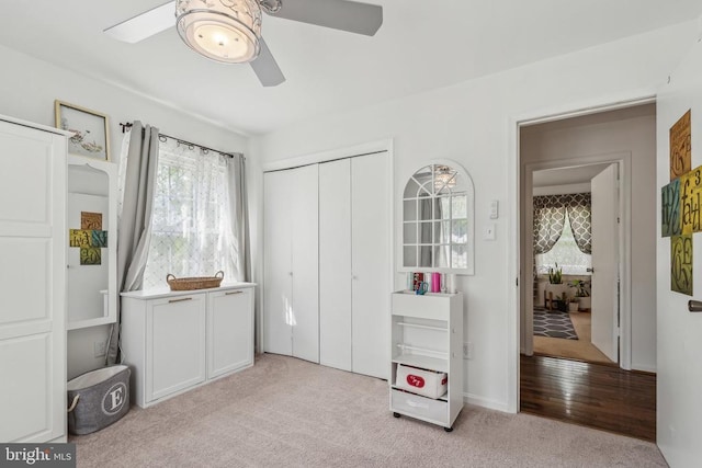  - bedroom with light colored carpet, a closet, and ceiling fan