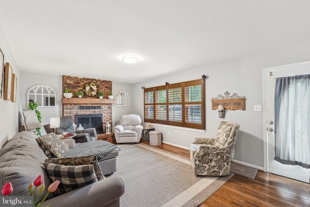  - living area with wood finished floors and a fireplace