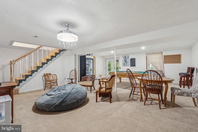  - living room with carpet flooring, stairs, and a textured ceiling