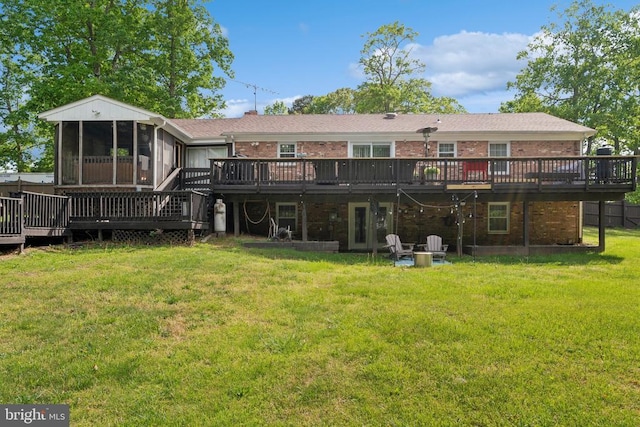  - rear view of property featuring brick siding, a deck, and a sunroom
